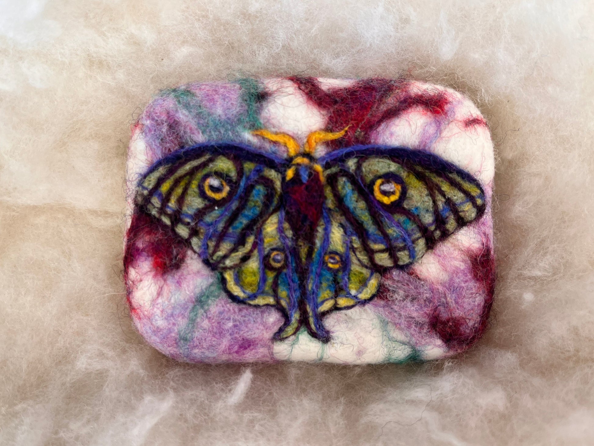 Colorful moth design on a felted soap