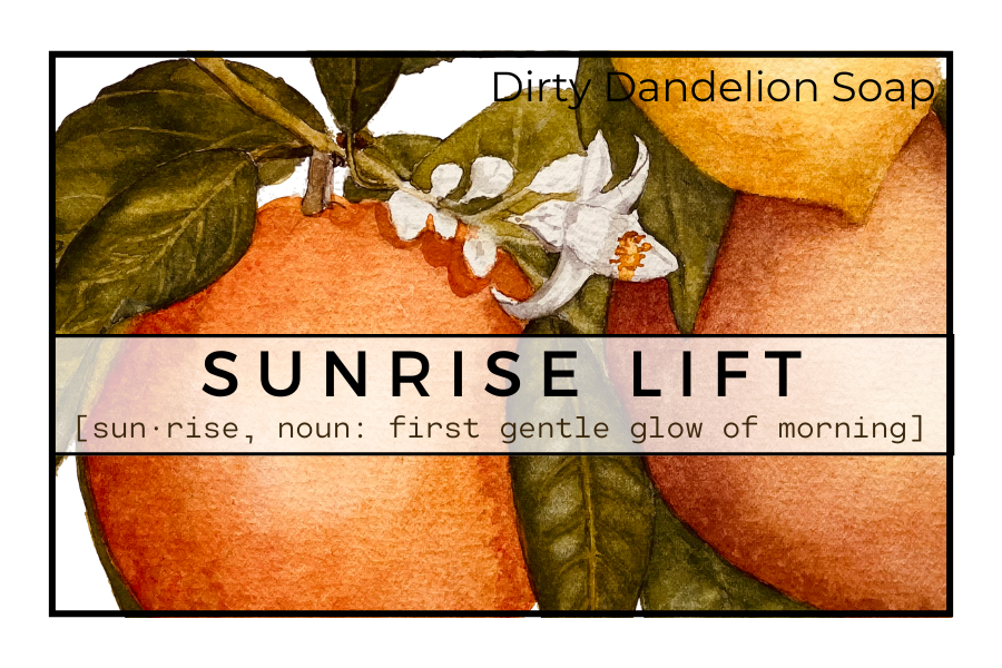 Watercolor label for Sunrise Lift featuring oranges, green leaves, and white blossoms, with the text Dirty Dandelion Soap and Sunrise Lift described as the first gentle glow of morning